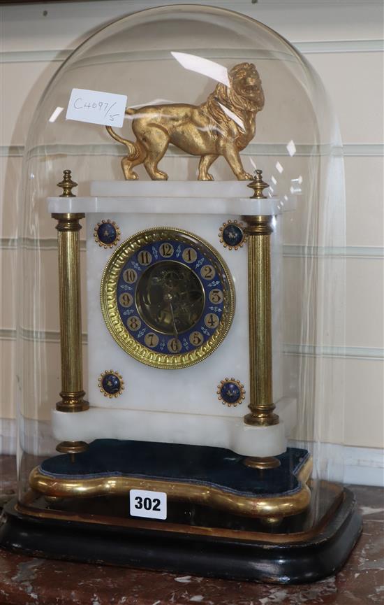 An alabaster clock surmounted with a lion, under glass dome